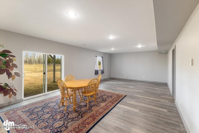 dining room featuring recessed lighting, light wood finished floors, plenty of natural light, and baseboards
