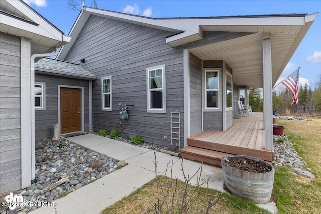 back of house featuring covered porch