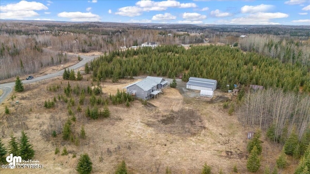 birds eye view of property with a forest view