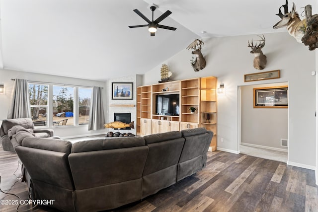living room featuring a fireplace, high vaulted ceiling, dark wood-type flooring, a ceiling fan, and visible vents