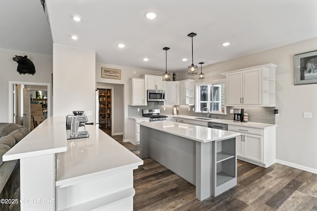 kitchen with tasteful backsplash, stainless steel appliances, open shelves, and a sink