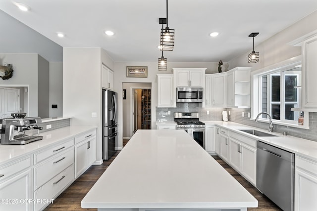 kitchen featuring backsplash, a sink, appliances with stainless steel finishes, and light countertops