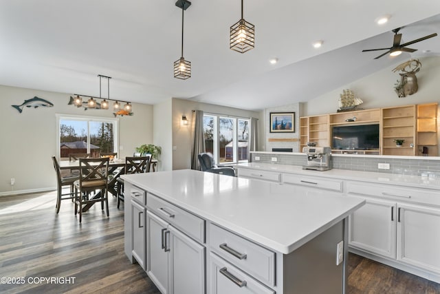 kitchen featuring decorative backsplash, a kitchen island, vaulted ceiling, dark wood-style floors, and open floor plan