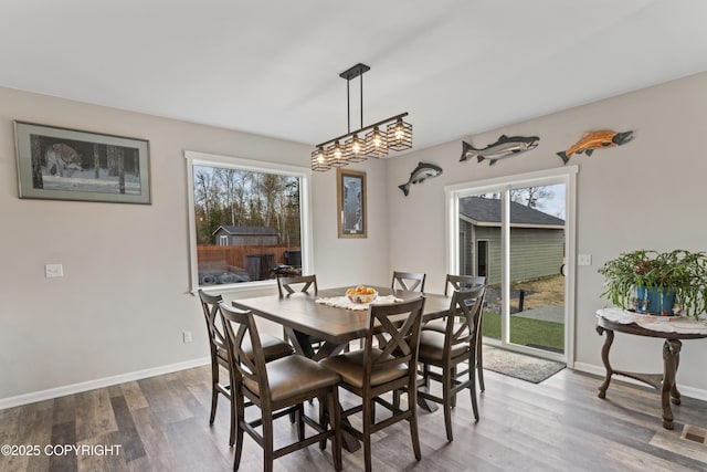 dining area featuring wood finished floors and baseboards