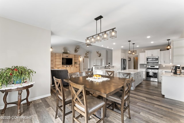 dining area with dark wood-style floors, recessed lighting, vaulted ceiling, and baseboards