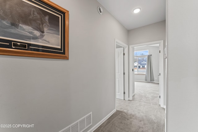 hallway with carpet and baseboards