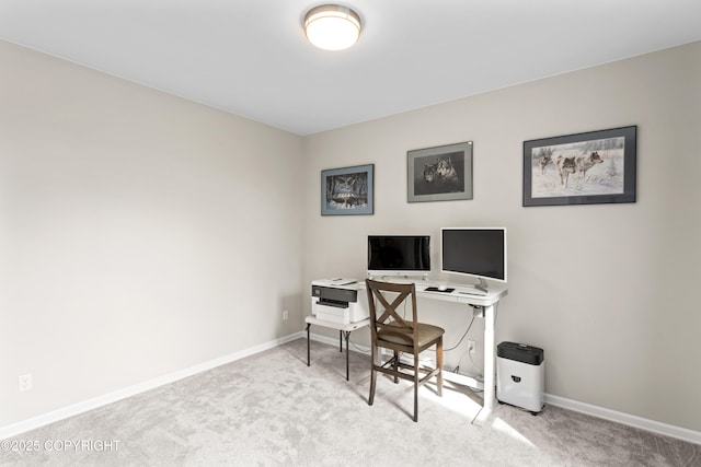 carpeted office featuring baseboards