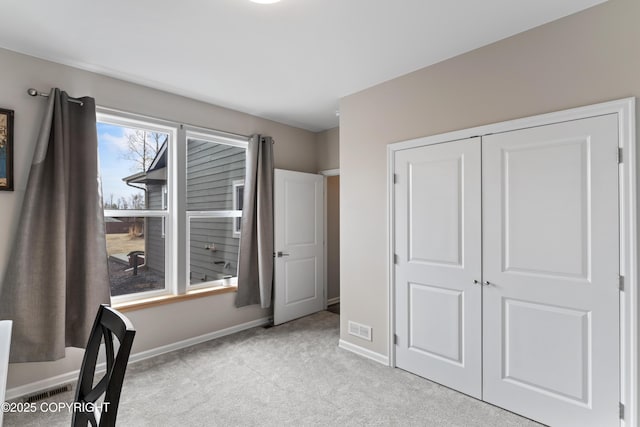 unfurnished bedroom featuring a closet, visible vents, carpet, and baseboards