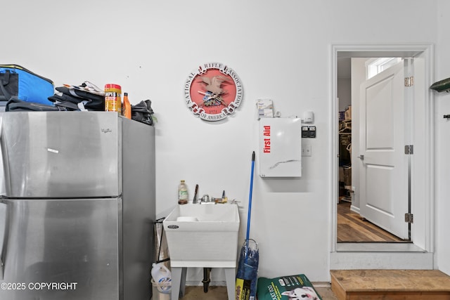 kitchen featuring a sink and freestanding refrigerator