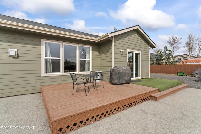 deck featuring a grill and fence
