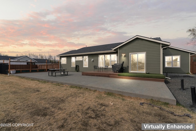 back of property with a patio, fence, and a yard