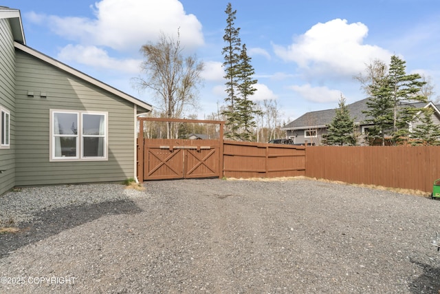 view of yard featuring fence and a gate
