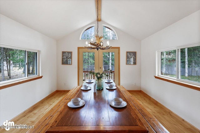 dining space featuring plenty of natural light, light wood-style flooring, and a chandelier