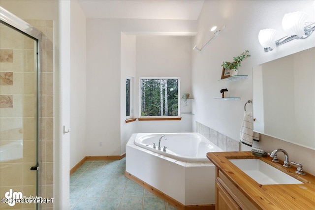 full bath featuring a garden tub, tile patterned floors, a stall shower, and vanity