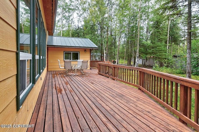 wooden deck featuring outdoor dining area