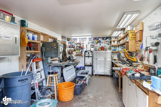 interior space with unfinished concrete floors and a workshop area