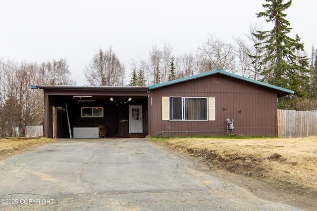 ranch-style home with fence, driveway, and a carport