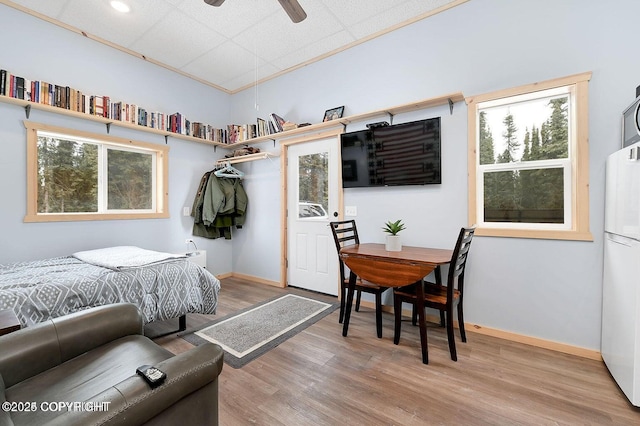 36696 Tammarack St, Soldotna, AK 99669 - bedroom featuring baseboards, freestanding refrigerator, and wood finished floors