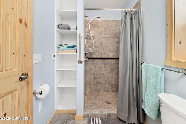 36696 Tammarack St, Soldotna, AK 99669 - full bathroom with tile patterned floors, a tile shower, and toilet