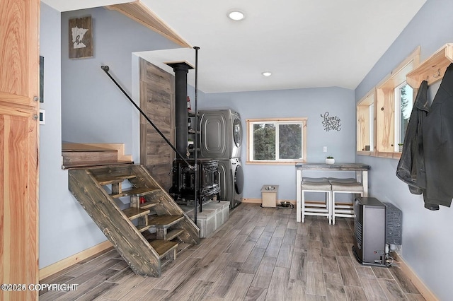 36696 Tammarack St, Soldotna, AK 99669 - interior space with a wood stove, recessed lighting, baseboards, stacked washer / dryer, and wood finished floors