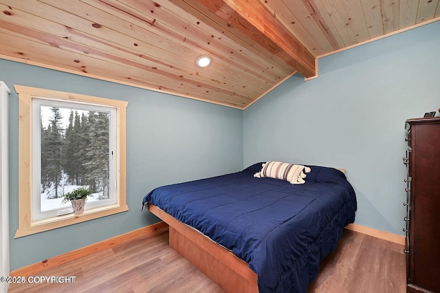 36696 Tammarack St, Soldotna, AK 99669 - bedroom featuring baseboards, lofted ceiling with beams, wood finished floors, and wooden ceiling