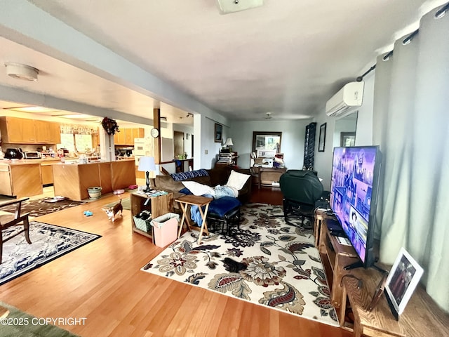 living room featuring a wall mounted air conditioner and light wood-style flooring