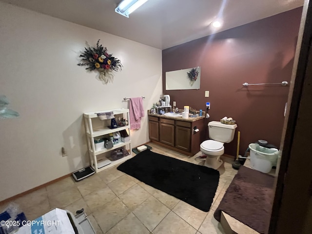 bathroom featuring tile patterned flooring, toilet, vanity, and baseboards