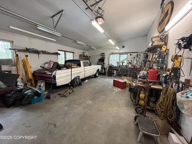 garage featuring a garage door opener and a workshop area
