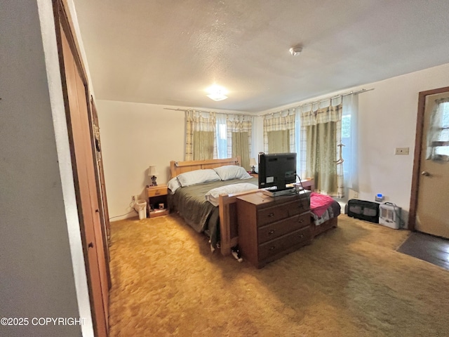 carpeted bedroom featuring a textured ceiling