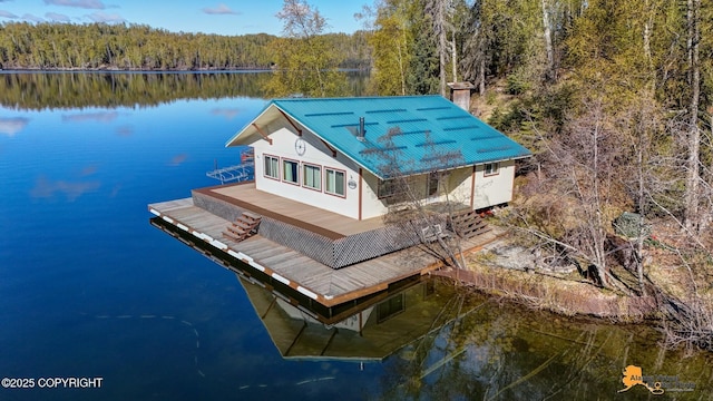 view from above of property featuring a heavily wooded area and a large body of water
