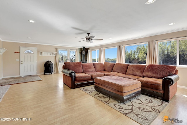 living area featuring recessed lighting, a ceiling fan, light wood finished floors, crown molding, and baseboards