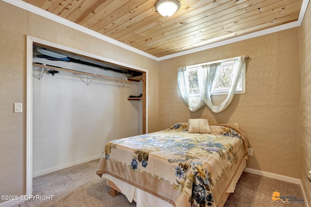 bedroom with crown molding, carpet, wooden ceiling, baseboards, and a closet