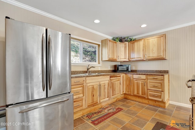 kitchen featuring freestanding refrigerator, light brown cabinets, a sink, crown molding, and black microwave