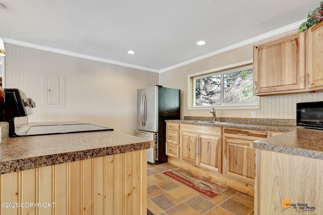 kitchen with light brown cabinetry, a sink, freestanding refrigerator, crown molding, and recessed lighting