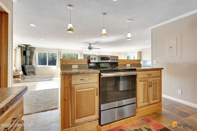 kitchen with stainless steel range with electric cooktop, a wood stove, baseboards, a ceiling fan, and open floor plan