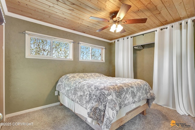 bedroom with wood ceiling, carpet flooring, crown molding, a ceiling fan, and baseboards