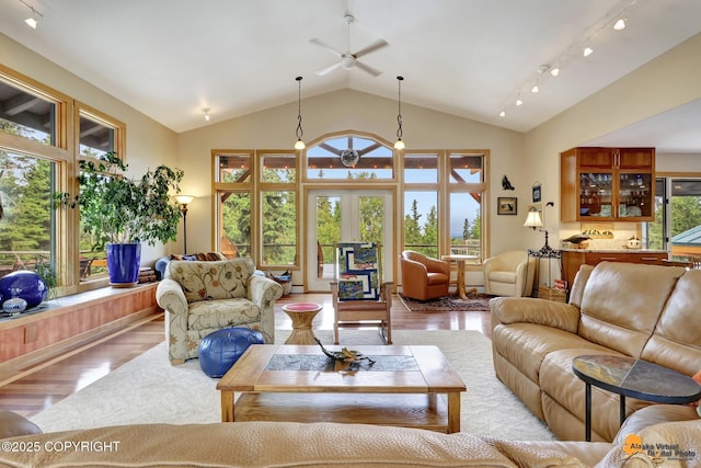 16900 Ransom Ridge Rd, Anchorage, AK 99516 - living room featuring wood finished floors, ceiling fan, vaulted ceiling, and french doors