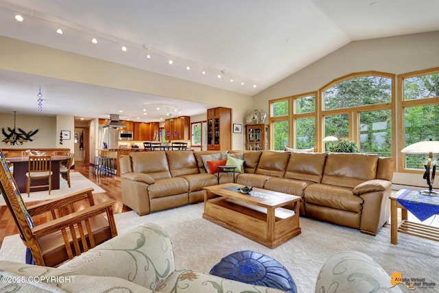 16900 Ransom Ridge Rd, Anchorage, AK 99516 - living room with lofted ceiling, a chandelier, recessed lighting, and light colored carpet