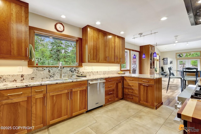 16900 Ransom Ridge Rd, Anchorage, AK 99516 - kitchen featuring dishwasher, a peninsula, brown cabinets, light stone counters, and tasteful backsplash