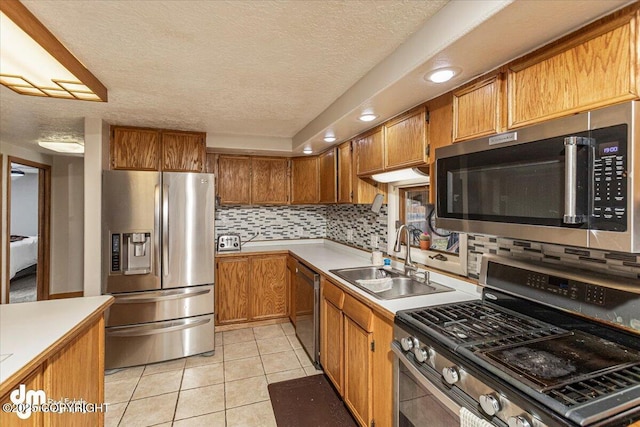 10209 Colville St, Eagle River, AK 99577 - kitchen with a sink, appliances with stainless steel finishes, brown cabinets, and light countertops