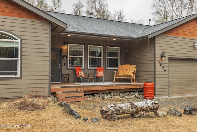3604 N Copperspike St, Wasilla, AK 99623 - view of exterior entry with covered porch, a shingled roof, and an attached garage