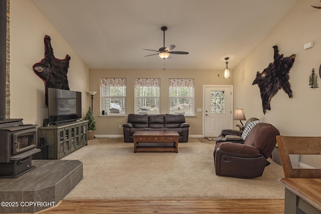 3604 N Copperspike St, Wasilla, AK 99623 - living area with ceiling fan, wood finished floors, a wood stove, and baseboards