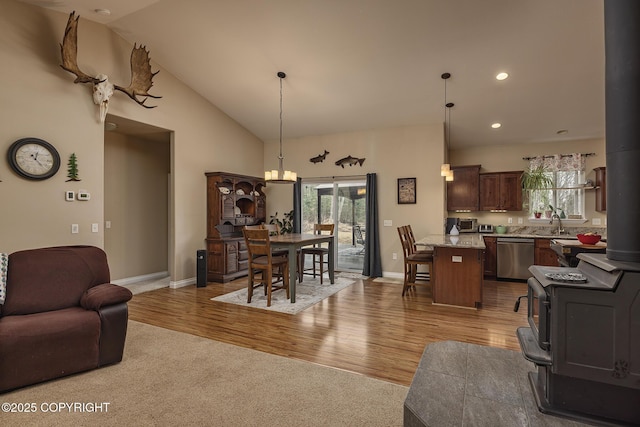 3604 N Copperspike St, Wasilla, AK 99623 - living area with light wood finished floors, baseboards, recessed lighting, vaulted ceiling, and a chandelier