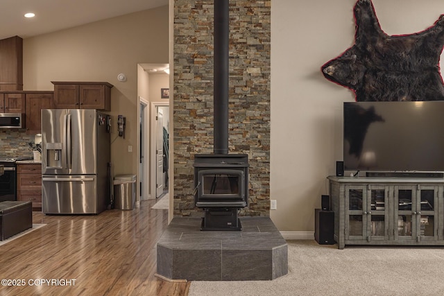 3604 N Copperspike St, Wasilla, AK 99623 - living area featuring a wood stove, vaulted ceiling, recessed lighting, wood finished floors, and baseboards