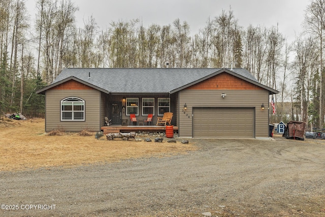 3604 N Copperspike St, Wasilla, AK 99623 - view of front of home featuring a porch, an attached garage, driveway, and a shingled roof