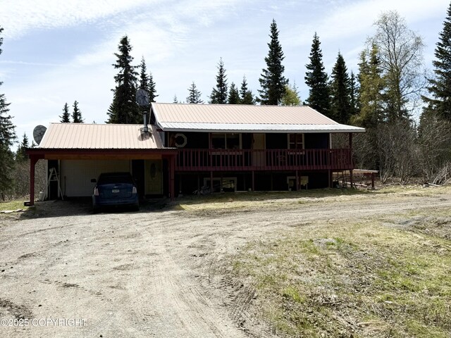 63531 Jessica G Ct, Ninilchik, AK 99639 - view of front of property with an attached carport, dirt driveway, and metal roof