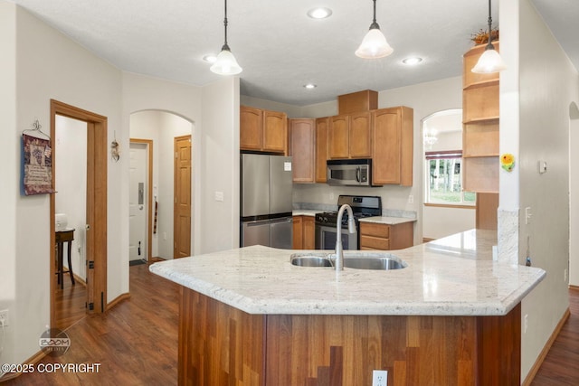 3600 N Fortune Cir, Wasilla, AK 99654 - kitchen featuring appliances with stainless steel finishes, arched walkways, a sink, open shelves, and a peninsula