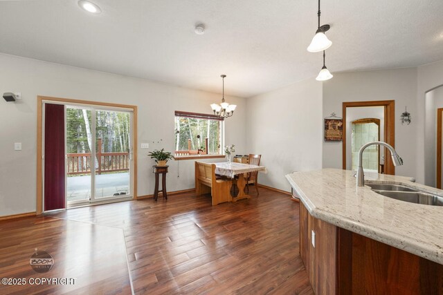 3600 N Fortune Cir, Wasilla, AK 99654 - kitchen with a sink, dark wood-style flooring, a chandelier, pendant lighting, and a center island