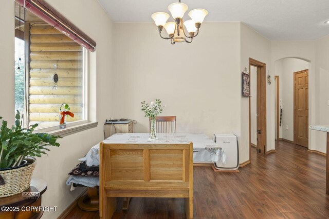 3600 N Fortune Cir, Wasilla, AK 99654 - dining room with arched walkways, dark wood-style floors, a chandelier, and baseboards