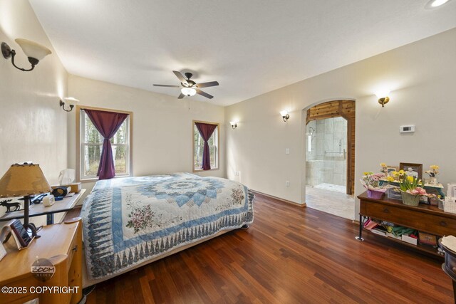 3600 N Fortune Cir, Wasilla, AK 99654 - bedroom featuring arched walkways, wood finished floors, and connected bathroom